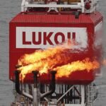FILE-PHOTO-A-gas-torch-is-seen-next-to-the-Lukoil-company-sign-at-the-Filanovskogo-oil-platform-in-t.jpeg