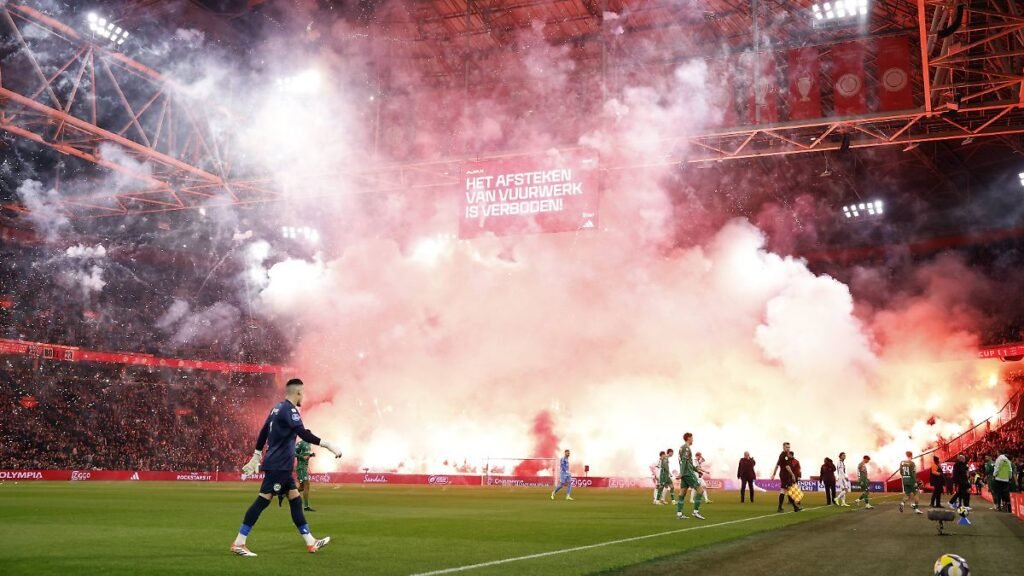 AMSTERDAM-Players-leave-the-field-of-play-due-to-fireworks-being-set-off-from-the-stands-in-tribute.jpeg