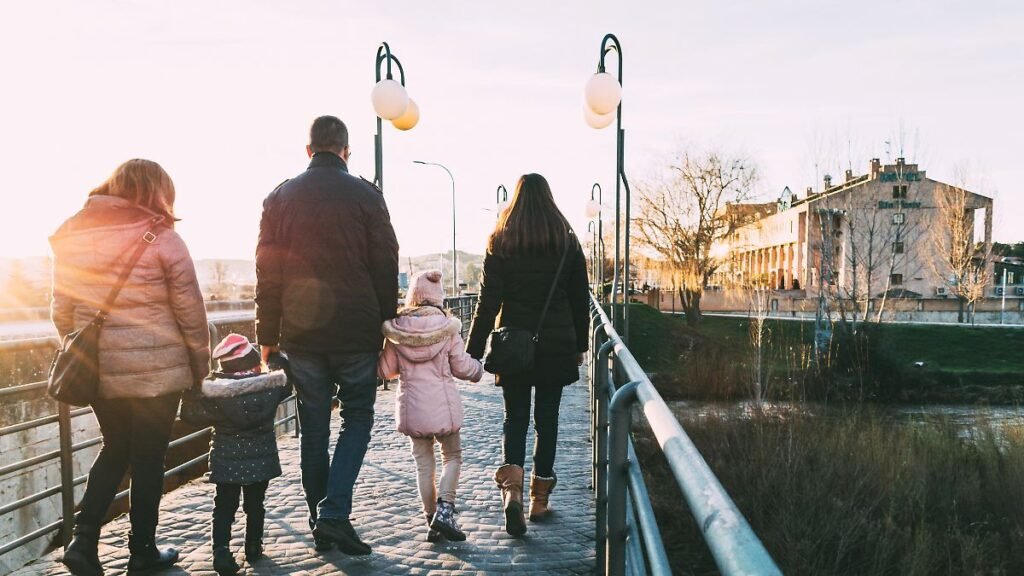 Father-walking-down-the-street-with-his-two-families-on-a-sunny-winter-s-afternoon.jpg