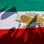 Demonstrators-cast-shadows-on-a-Lion-and-Sun-pre-Iranian-Revolution-national-flag-during-a-rally-in.jpeg