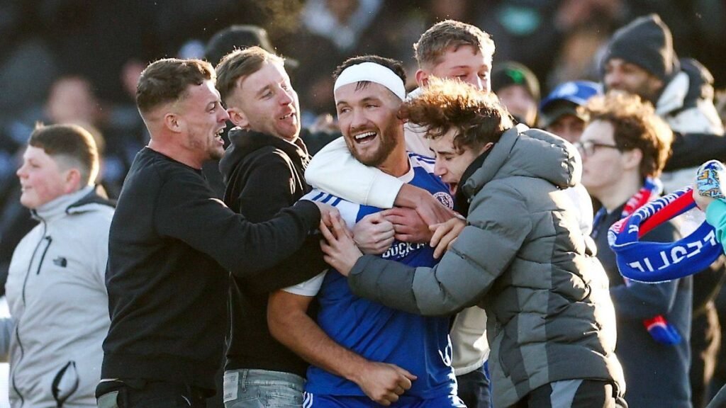 Paul-Dawson-of-Macclesfield-FC-is-mobbed-by-fans-on-the-final-whistle-Macclesfield-v-Crystal-Palace.jpeg