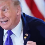 president-donald-trump-wears-a-gift-which-he-calls-a-happy-trump-pin-during-a-meeting-with-oil-execu.webp