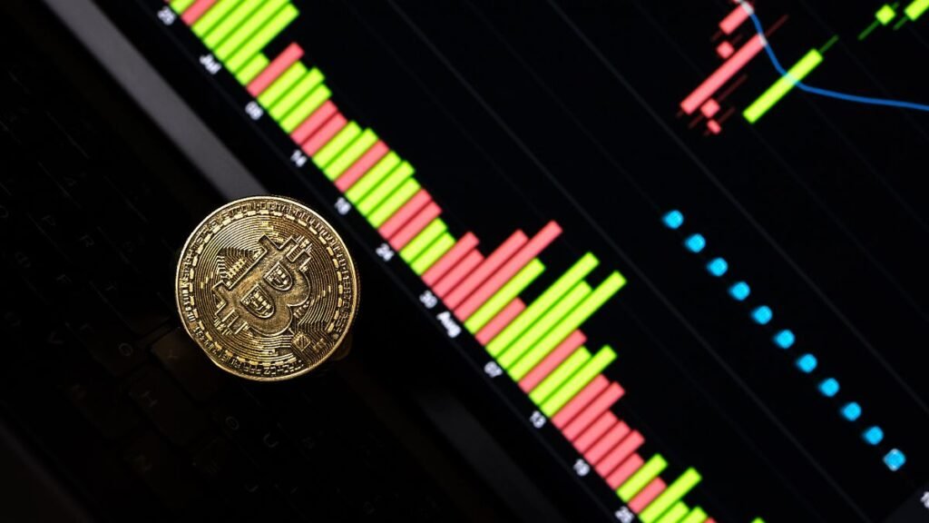A-physical-representation-of-Bitcoin-and-a-stock-exchange-curve-chart-display-as-the-background-on-a.jpeg