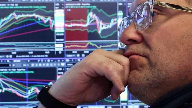 A-specialist-trader-works-at-his-post-on-the-floor-at-the-New-York-Stock-Exchange-NYSE-in-New-York-C.jpeg