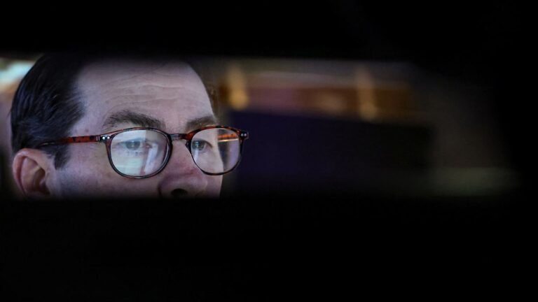 A-trader-works-on-the-floor-at-the-New-York-Stock-Exchange-NYSE-in-New-York-City-U-S-February-25-202.jpeg