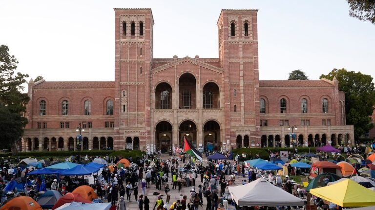FILE-Demonstrators-walk-in-an-encampment-on-the-UCLA-campus-after-clashes-between-pro-Israel-and-pro.jpeg