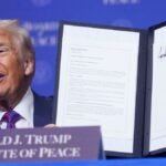 President-Donald-Trump-holds-up-a-signed-resolution-during-a-Board-of-Peace-meeting-at-the-U-S-Insti.jpeg