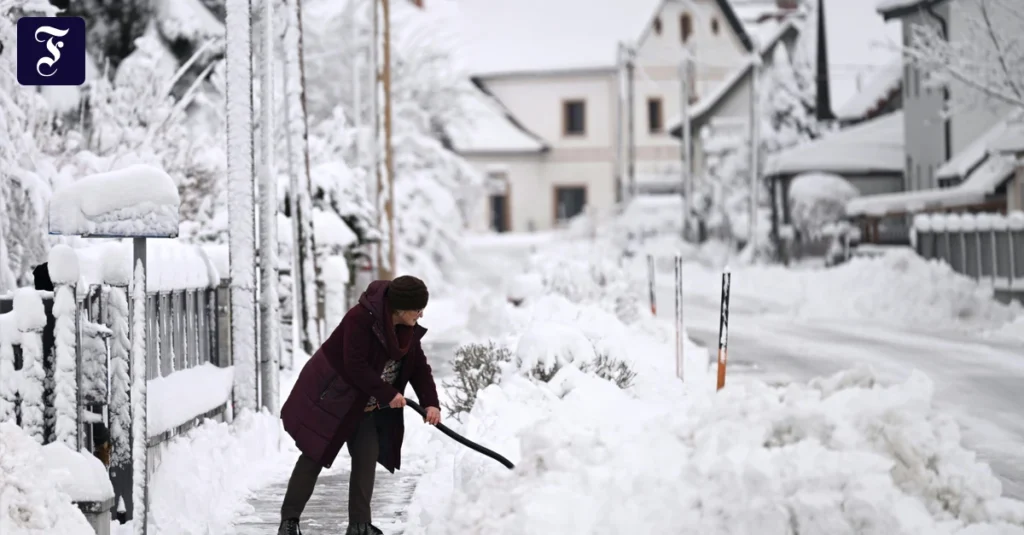 eine-frau-raeumt-schnee-im.webp.webp
