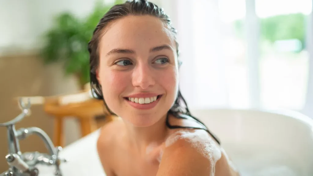 relaxed-young-woman-enjoying-self-care-and-hair-wash-in-bathtub-relaxed-young-woman-enjoying-self-ca.webp