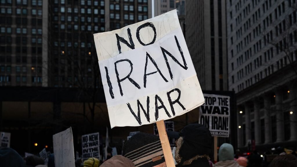 A-protester-holds-placards-reading-No-Iran-war-during-a-demonstration-against-the-war-in-Iran-in-Chi.jpeg