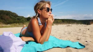 middle-aged-blonde-woman-smoking-on-the-beach-in-bikini-xkwx-beach-girl-smoke-young-beautiful-bikini.webp