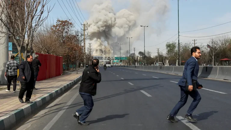 people-run-as-smoke-rises-following-an-explosion-amid-the-us-israeli-conflict-with-iran-in-tehran-ir.webp