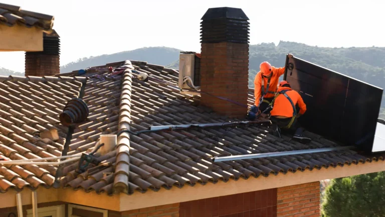 technicians-installing-solar-panel-on-roof-in-barcelona-with-teamwork-model-released-symbolfoto-prop.webp