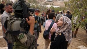 A-Palestinian-woman-speaks-to-an-Israeli-soldier-in-the-village-of-Edna-north-of-the-occupied-West-B.jpeg