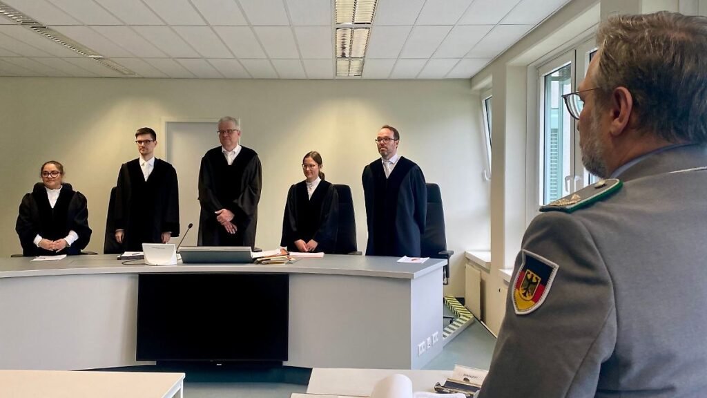 Der-Vorsitzende-Richter-Egbert-Schneider-3-v-l-steht-vor-dem-Prozessvertreter-der-Bundeswehr-r-zu-Be.jpeg