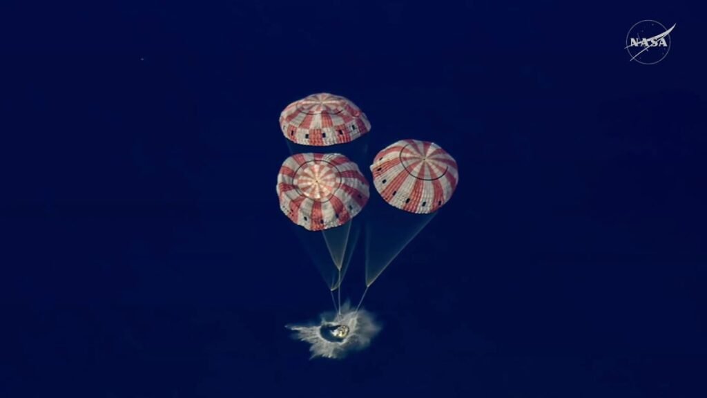 In-this-image-from-video-provided-by-NASA-the-Artemis-II-Orion-capsule-splashes-down-in-the-Pacific.jpeg