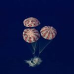 In-this-image-from-video-provided-by-NASA-the-Artemis-II-Orion-capsule-splashes-down-in-the-Pacific.jpeg