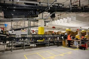 an-us-giant-amazon-employee-prepares-an-order-on-the-opening-day-of-the-new-distribution-center-in-a.jpeg