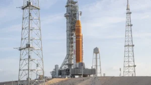 nasas-artemis-ii-space-launch-system-sls-rocket-and-orion-spacecraft-are-seen-standing-atop-a-mobile.webp