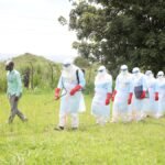 260521-BUNIA-May-21-2026-Xinhua-Medical-workers-conduct-disinfection-before-the-burial-of-a-suspecte.jpeg