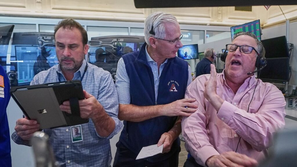 Options-trader-left-to-right-Scott-Frinzi-Dave-Rushand-and-Marty-Handler-work-on-the-floor-of-the-Ne.jpeg