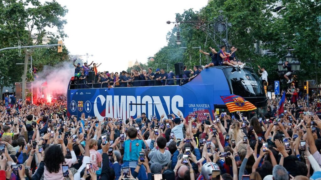 Surrounded-by-supporters-FC-Barcelona-players-celebrate-atop-a-bus-after-winning-the-Spanish-La-Liga.jpeg