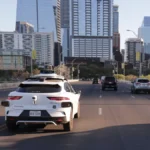 march-20-2026-austin-tx-usa-a-a-driverless-waymo-taxi-heads-s-s-over-the-first-street-bridge-in-down.webp