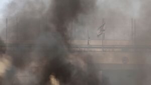 An-Israeli-flag-is-seen-through-smoke-from-fire-in-a-field-which-local-Palestinians-say-has-been-set.jpeg