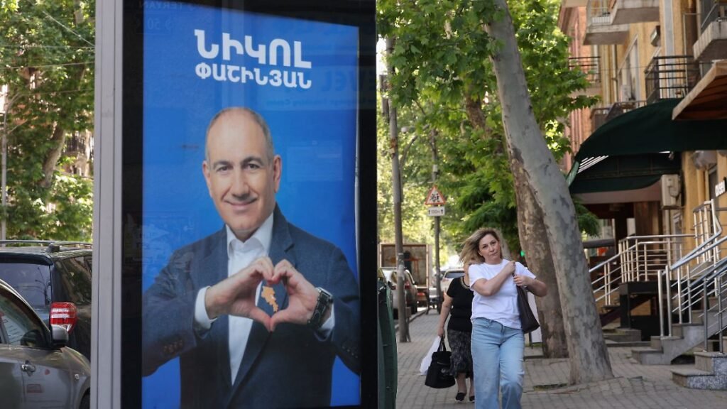 People-walk-past-campaign-banners-with-portraits-of-Prime-Minister-Nikol-Pashinyan-of-the-Civil-Cont.jpeg