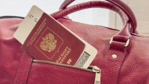 Red-passport-and-boarding-pass-are-sticking-out-of-the-pocket-of-the-bag-Red-Russian-passport-with-a.jpeg
