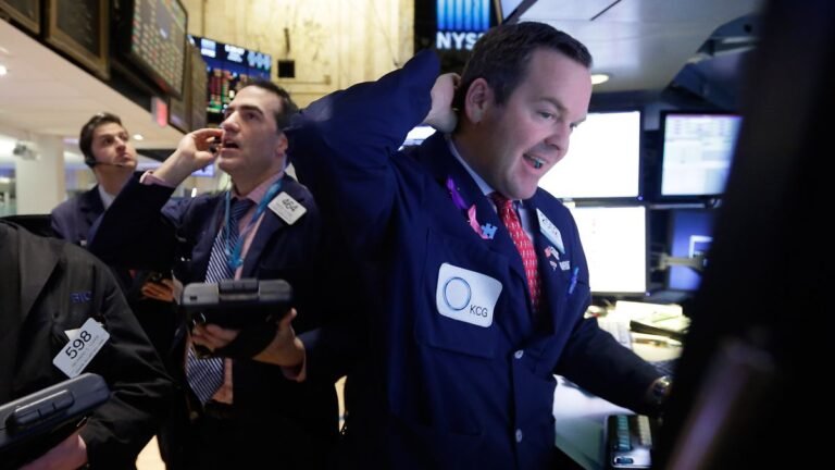 Specialist-Charles-Boeddinghaus-right-works-with-traders-on-the-floor-of-the-New-York-Stock-Exchange.jpeg