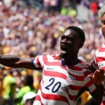 folarin-balogun-of-usa-and-antonee-robinson-of-usa-celebrate-an-own-goal-by-cameron-burgess-of-austr.webp