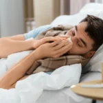 people-and-health-problem-concept-unhappy-sick-man-blowing-nose-lying-in-bed-at-home-sick-man-blowin.webp